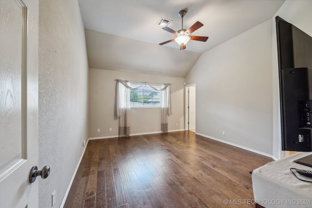 interior space featuring ceiling fan, vaulted ceiling, and dark hardwood / wood-style flooring