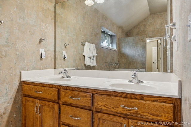 bathroom with vanity and lofted ceiling