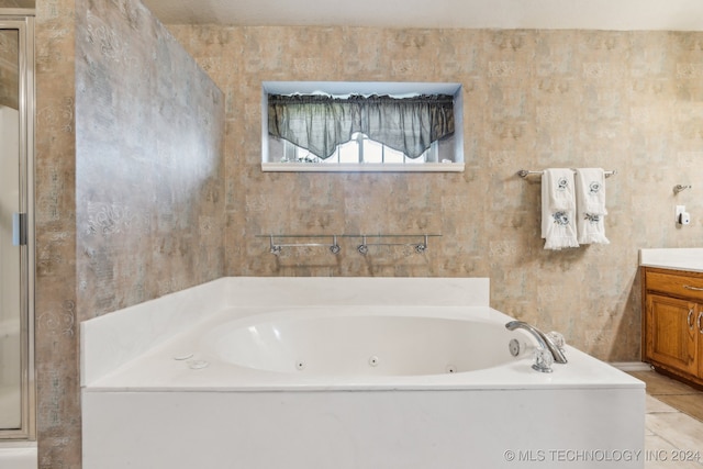 bathroom featuring vanity, tile patterned floors, and a bathing tub