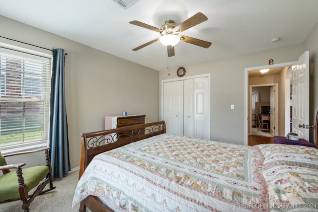 bedroom with a closet, ceiling fan, multiple windows, and light colored carpet