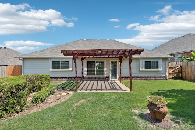 rear view of property with a patio, a yard, and a pergola