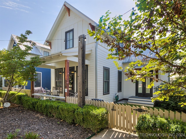 rear view of property with a porch