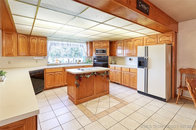 kitchen with black appliances, a kitchen island, and light tile patterned floors