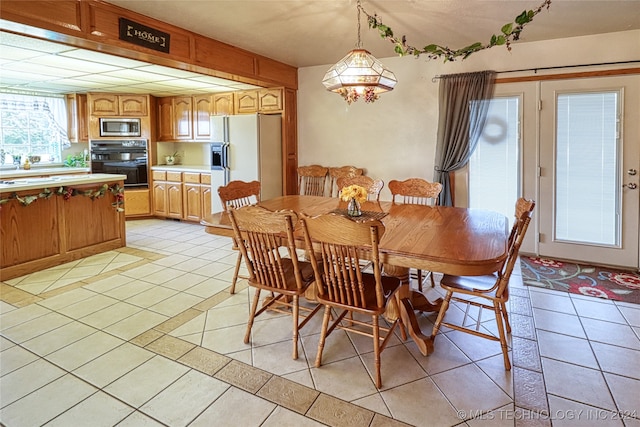 dining space featuring light tile patterned floors