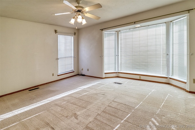 spare room with ceiling fan and carpet floors