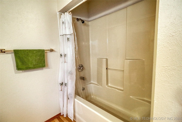 bathroom featuring shower / bath combo and hardwood / wood-style flooring