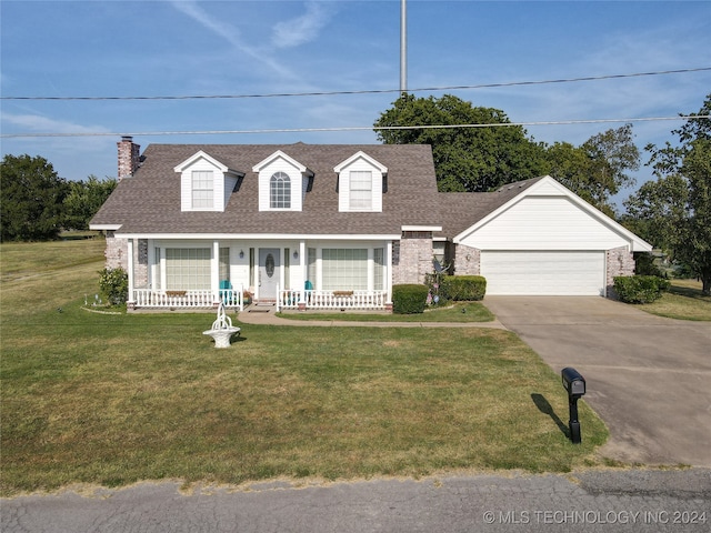 cape cod-style house featuring a garage, an outdoor structure, a front lawn, and a porch