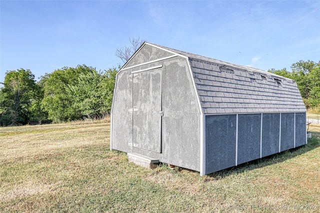 view of outdoor structure featuring a lawn