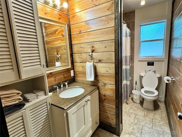 bathroom with tile patterned floors, vanity, and toilet