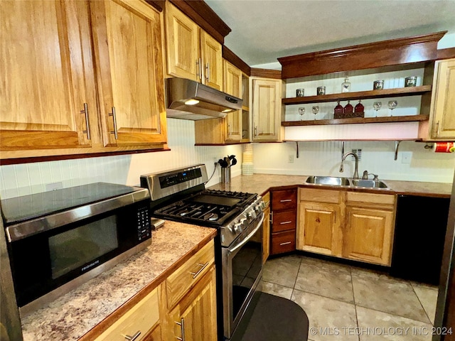 kitchen featuring sink, stainless steel appliances, and light tile patterned floors