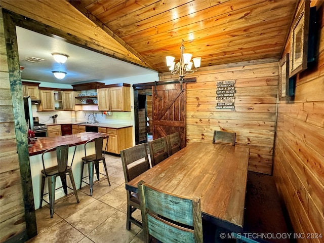 dining area with wooden ceiling, a barn door, light tile patterned floors, vaulted ceiling, and sink