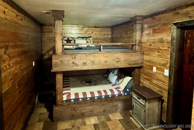 interior space featuring wood walls and tile patterned flooring