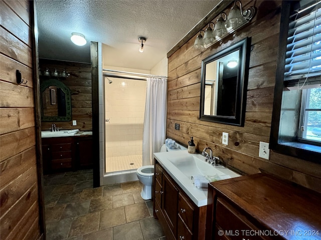 bathroom featuring wood walls, toilet, vanity, and a shower with shower curtain