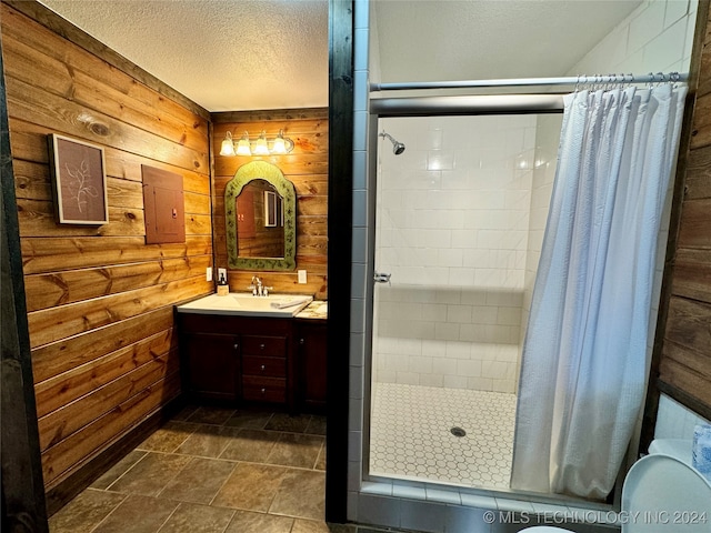 bathroom featuring electric panel, wood walls, vanity, and tile patterned floors