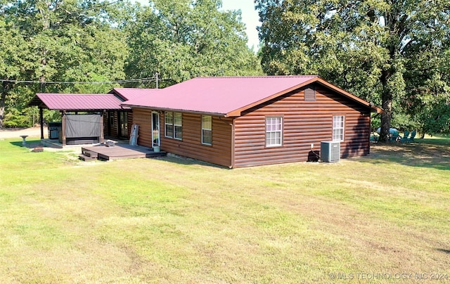 view of front of home with central AC and a front lawn