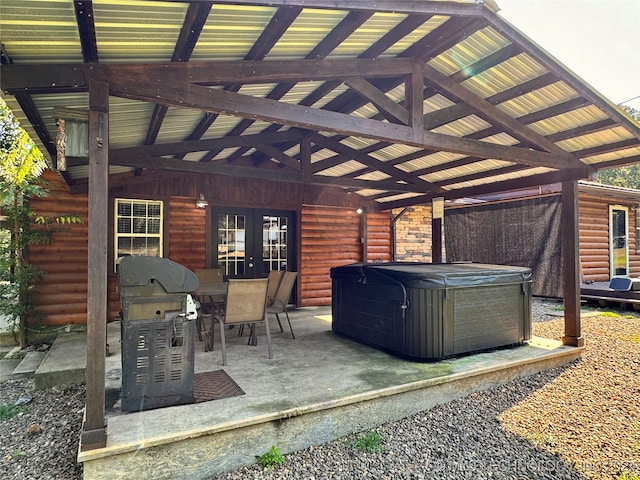 view of patio / terrace with grilling area, french doors, and a hot tub