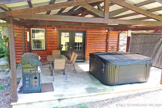 view of patio / terrace with a hot tub, area for grilling, and french doors