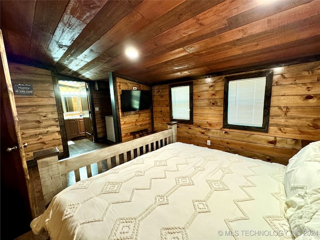 bedroom featuring vaulted ceiling, wooden walls, and wood ceiling