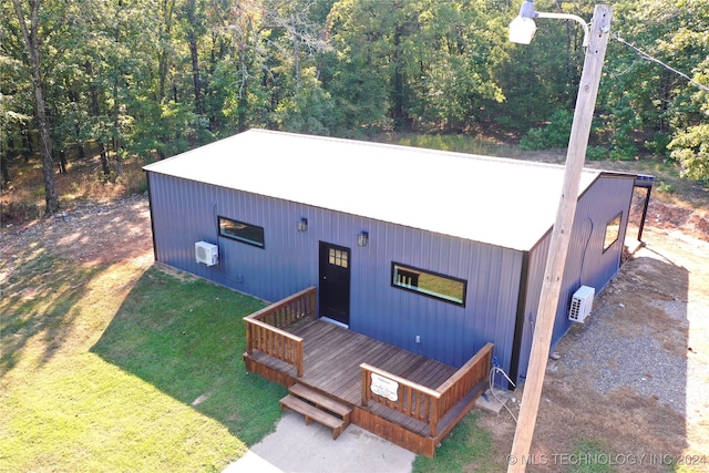 exterior space with a wooden deck and a front yard