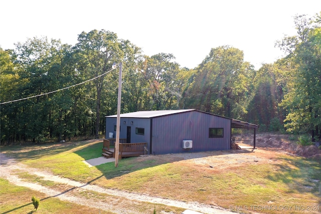 view of side of home featuring a wooden deck and a yard