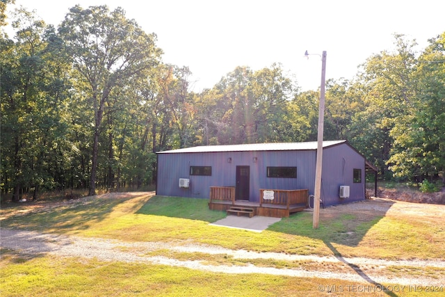 view of front of house featuring a front lawn and a deck