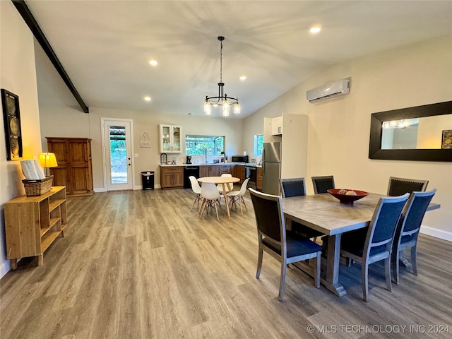 dining space with an AC wall unit, vaulted ceiling, hardwood / wood-style flooring, and a chandelier