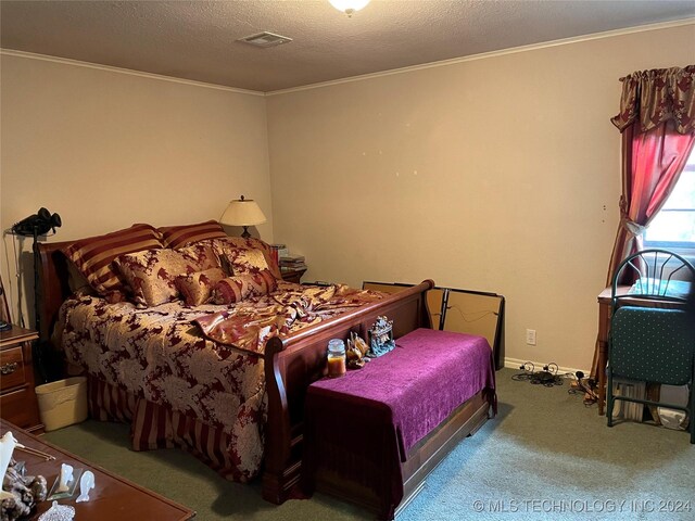 bedroom with a textured ceiling and carpet