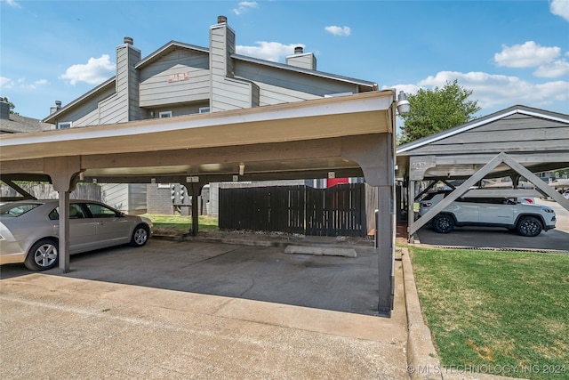 view of parking with a yard and a carport