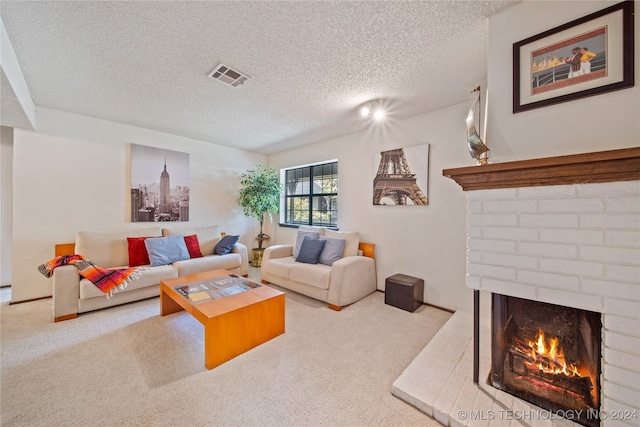 carpeted living room with a fireplace and a textured ceiling