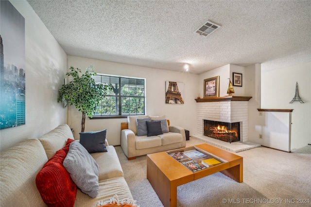 living room featuring carpet flooring, a textured ceiling, and a brick fireplace