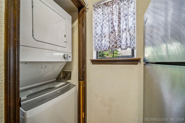 clothes washing area with stacked washer / drying machine