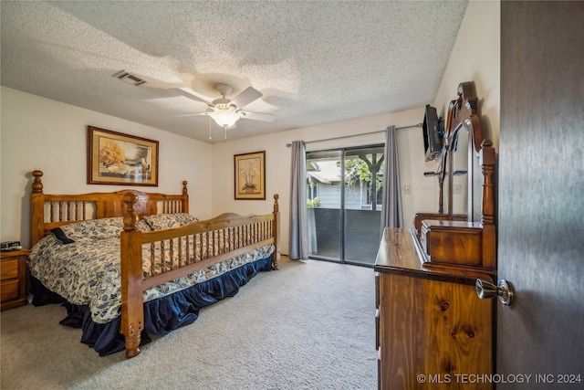 carpeted bedroom with a textured ceiling, access to exterior, and ceiling fan