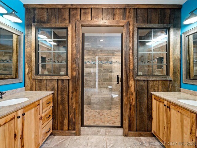 bathroom with wooden walls, vanity, and walk in shower