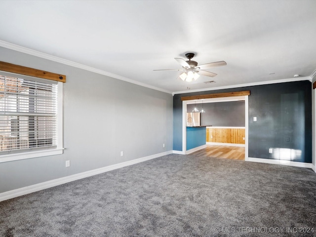 carpeted empty room with ceiling fan and ornamental molding