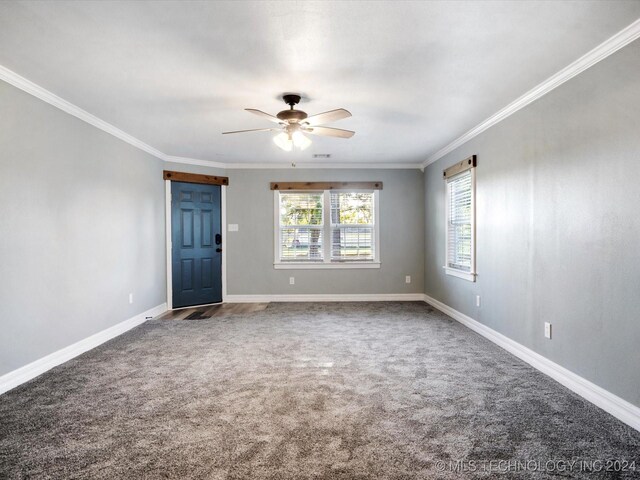 spare room featuring crown molding, plenty of natural light, carpet floors, and ceiling fan