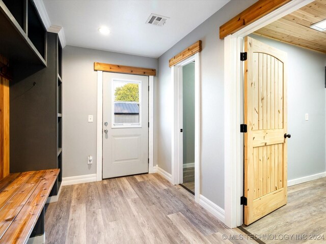 mudroom with wood ceiling and light hardwood / wood-style flooring