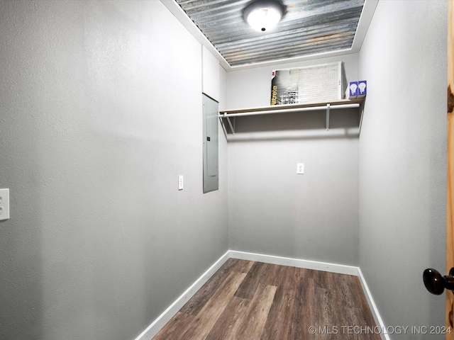 spacious closet with dark hardwood / wood-style floors and electric panel