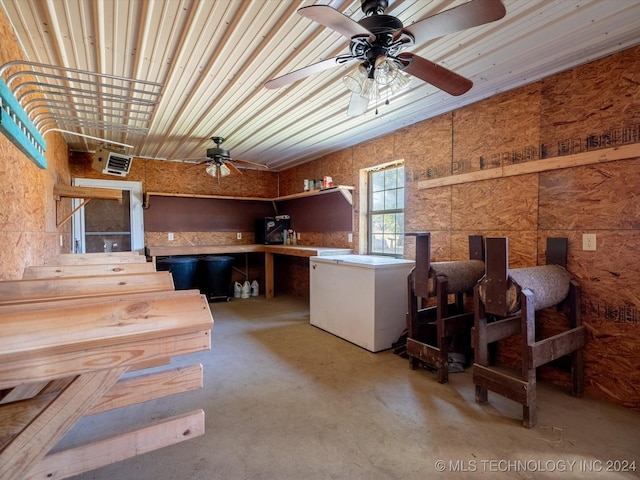 interior space with ceiling fan and concrete floors