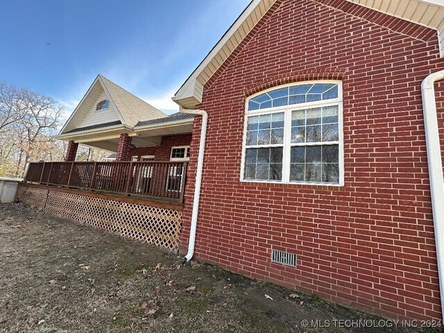 view of side of home with a deck