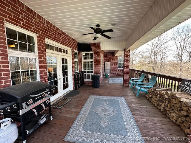 wooden deck with ceiling fan, french doors, and area for grilling