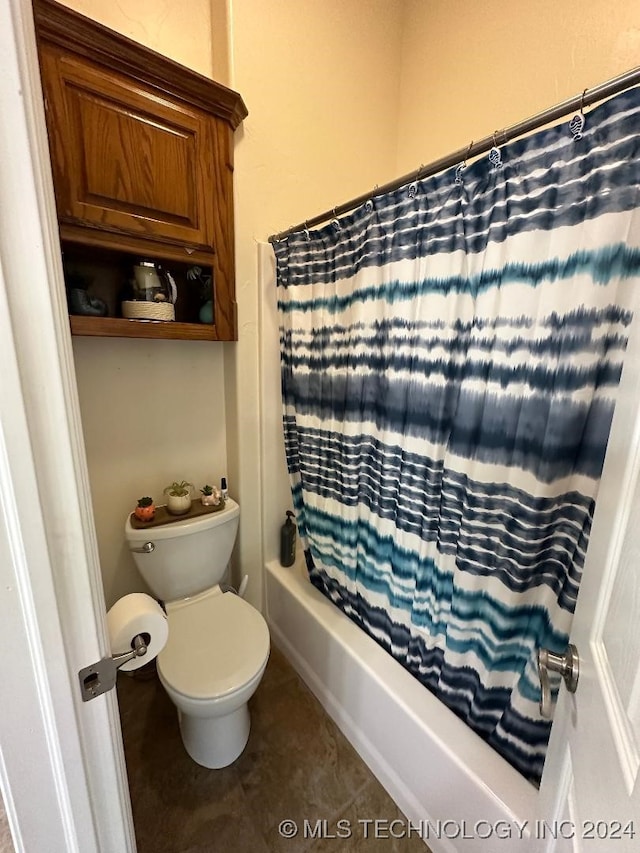 bathroom with shower / tub combo with curtain, tile patterned floors, and toilet