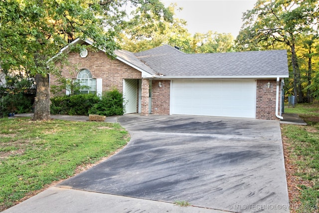 ranch-style home with a garage and a front yard