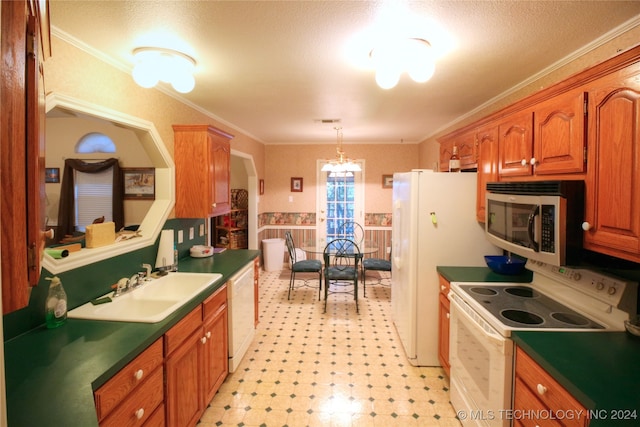 kitchen with white appliances, hanging light fixtures, light tile patterned flooring, sink, and ornamental molding