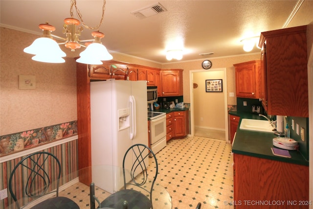 kitchen with crown molding, white appliances, hanging light fixtures, sink, and a chandelier