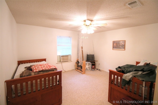 carpeted bedroom featuring a textured ceiling, cooling unit, and ceiling fan