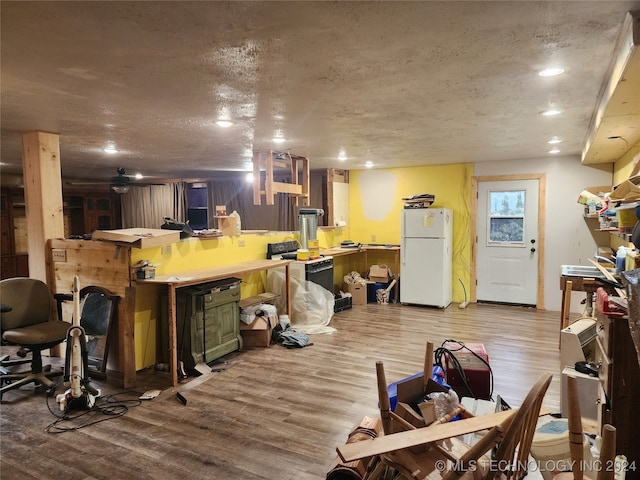 interior space with light hardwood / wood-style flooring and a textured ceiling