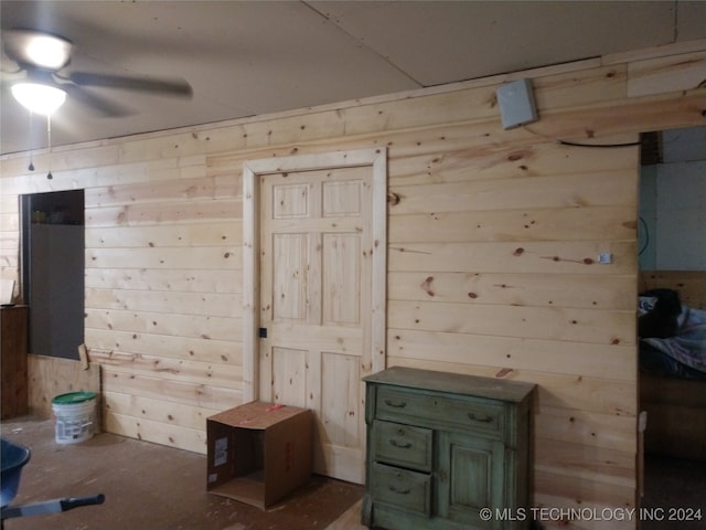 bedroom featuring wood walls