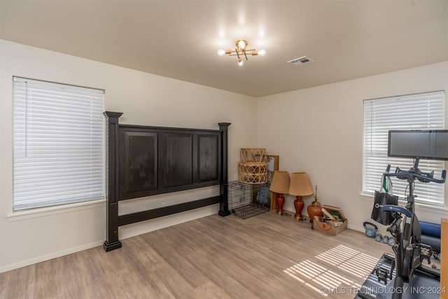 interior space with a notable chandelier and light hardwood / wood-style floors