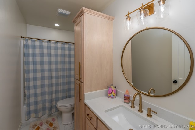 bathroom featuring vanity, toilet, and tile patterned flooring