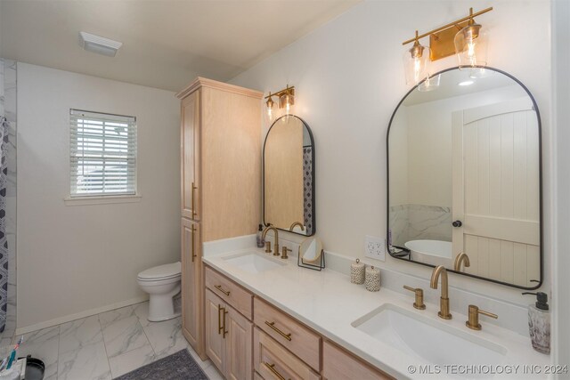 bathroom featuring a tub, double vanity, tile patterned flooring, and toilet